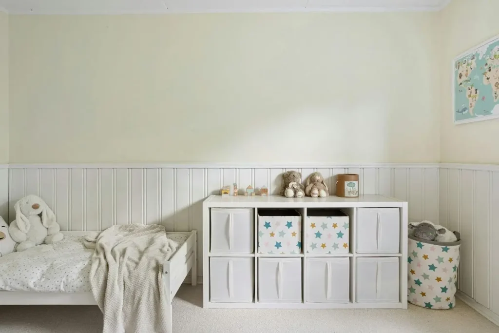 White cube shelving unit with fabric storage bins doubling as room decor