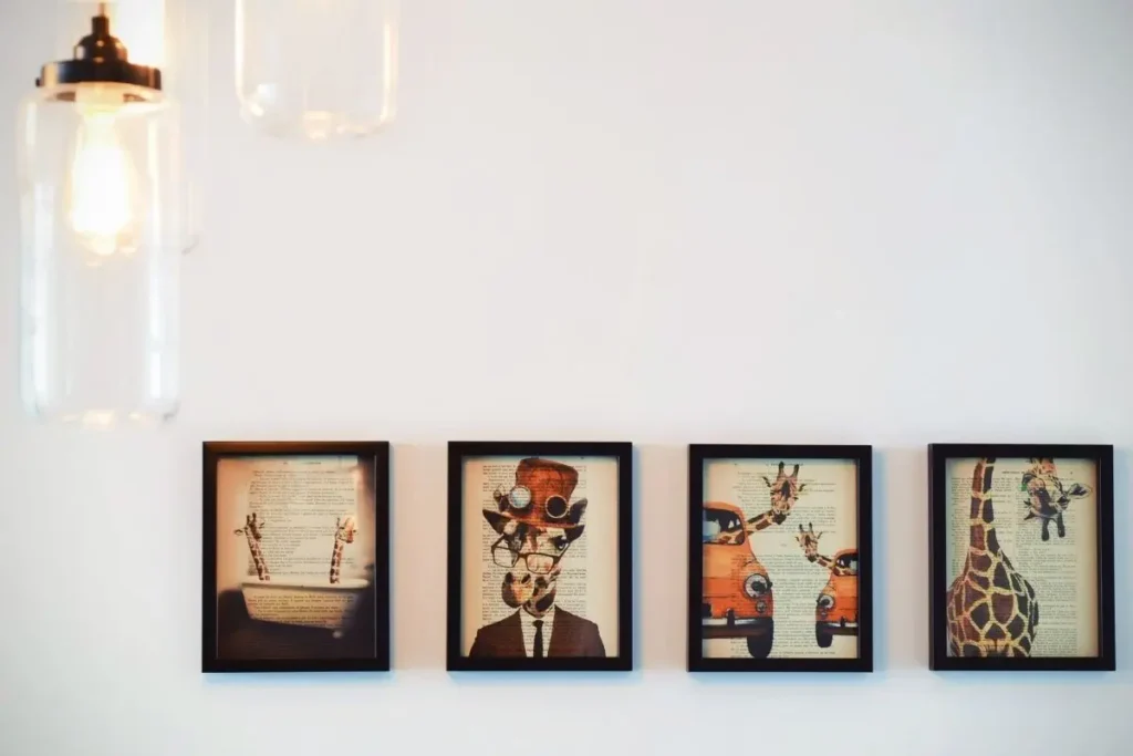 Gallery wall with mismatched black frames and quirky prints in a small apartment