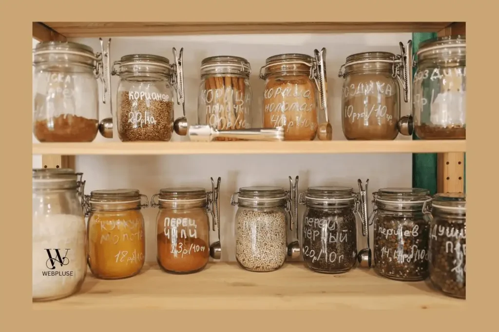 Minimalist Small Kitchen on a Tight Budget: 6 Simple Ideas 2 labeled clear glass jars on open wooden shelves for small kitchen budget storage.