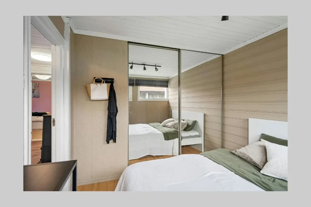 7 common wardrobe design mistakes in small bedrooms 4 mirrored sliding wardrobe door bouncing natural sunlight in small bedroom.