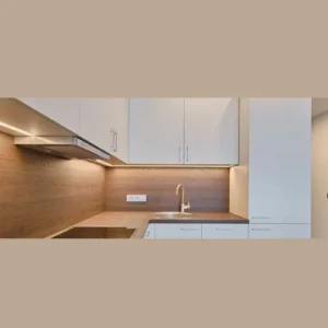 No-Drill Under-Cabinet Lighting Ideas for Rental Kitchens 5 peel and stick LED strip lights running under kitchen cabinets with wooden backsplash.