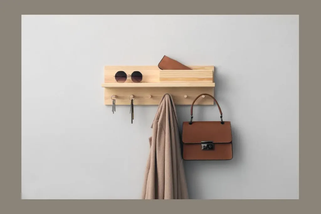 wooden wall mounted key holder pegboard with handbag and jacket hooks.